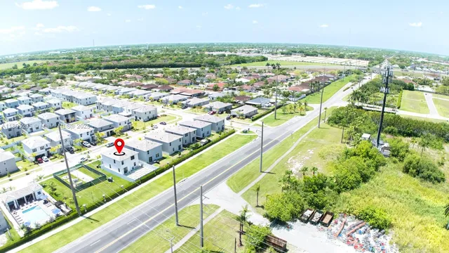 an aerial view of a house with a swimming pool