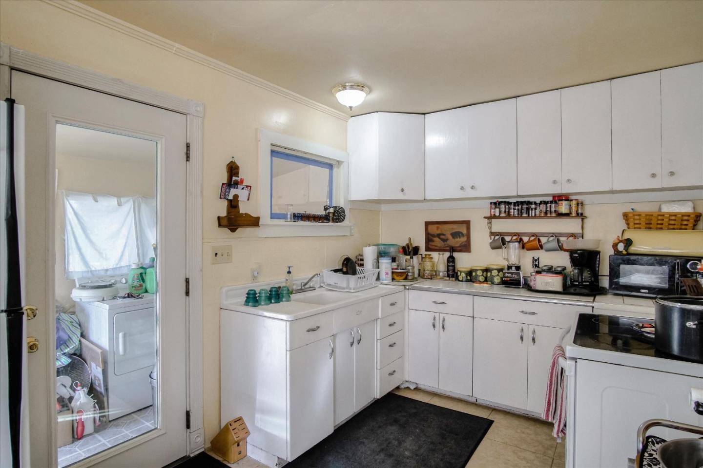6520 Fairview Road Hollister, CA 95023 - Photo 12 of 39 a kitchen with white cabinets and white appliances