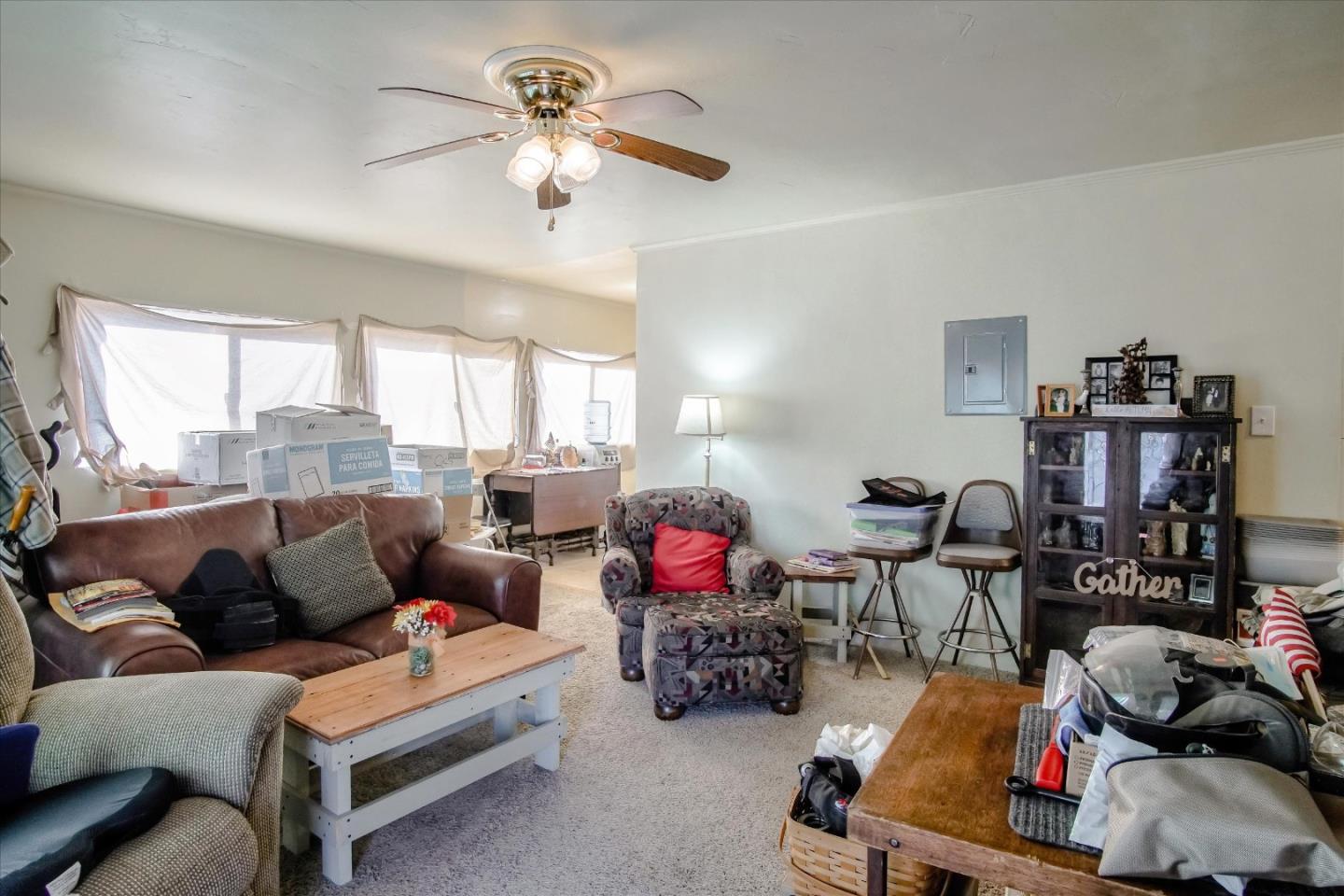6520 Fairview Road Hollister, CA 95023 - Photo 10 of 39 a living room with furniture a fireplace and a chandelier