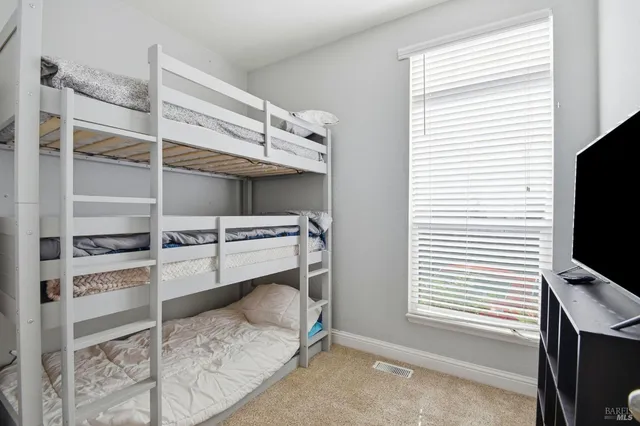 a room with a chair and a flat screen tv