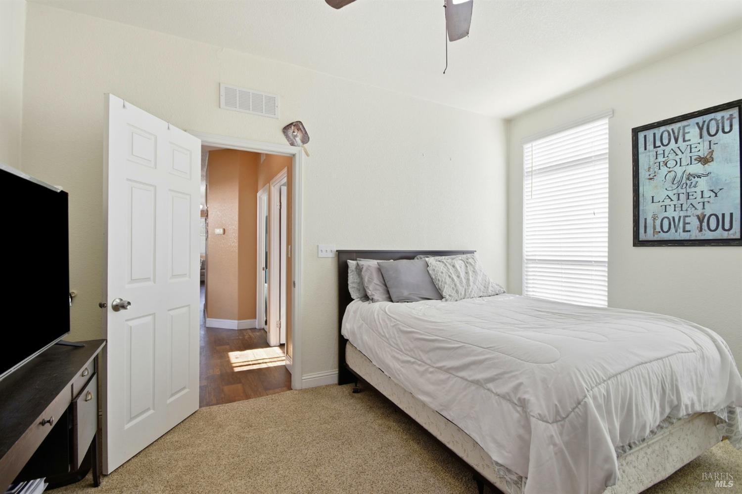 5501 Ranchito Way Santa Rosa, CA 95403 - Photo 15 of 20 a bedroom with a bed and a flat tv screen on the dresser