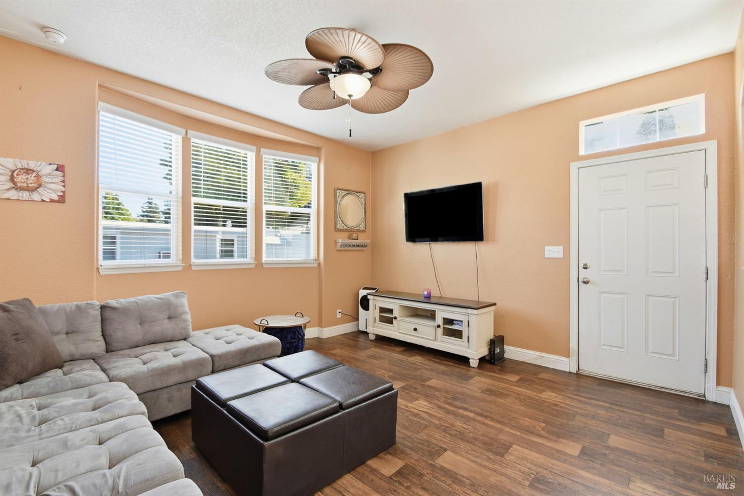 5501 Ranchito Way Santa Rosa, CA 95403 - Photo 6 of 20 a living room with furniture flat screen tv and wooden floor