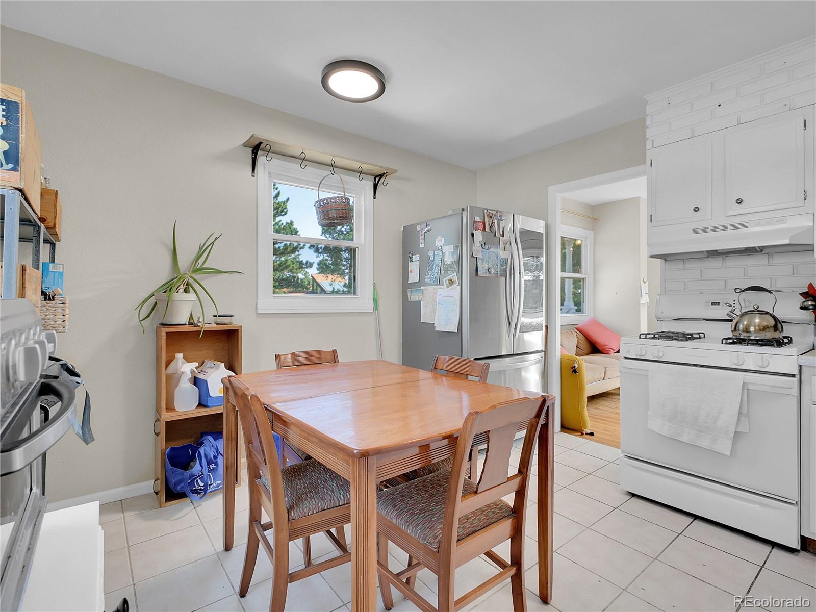 660 West Spruce Street Nederland, CO 80466 - Photo 13 of 29 a kitchen with a table chairs and a refrigerator
