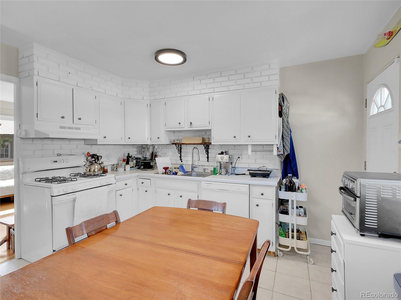 660 West Spruce Street Nederland, CO 80466 - Photo 14 of 29 a kitchen with appliances a sink and cabinets