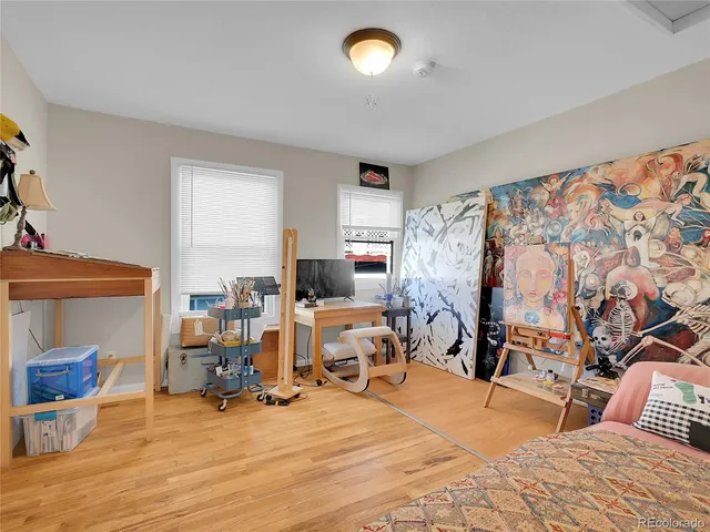 a view of a livingroom with workspace and a window