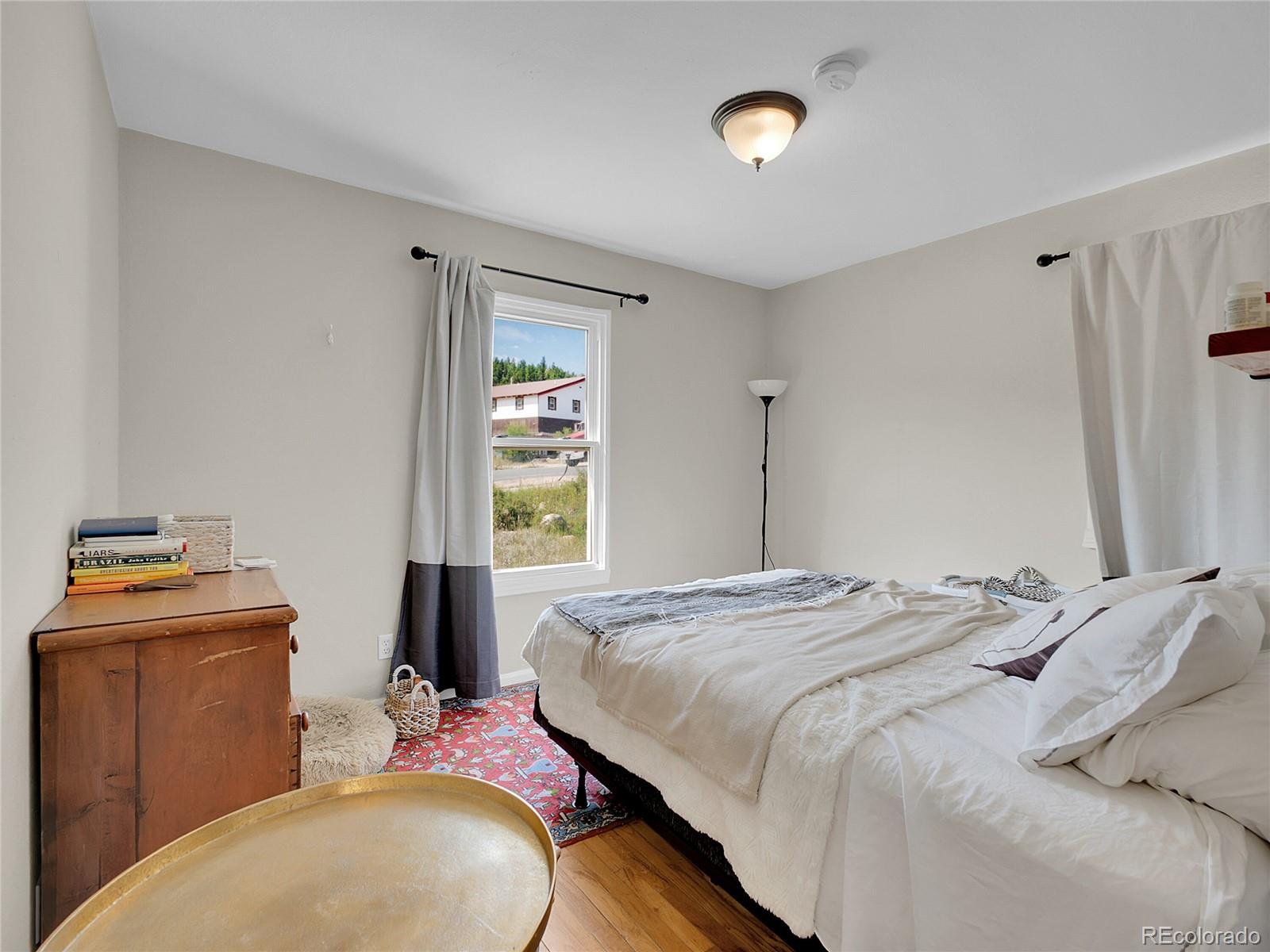 660 West Spruce Street Nederland, CO 80466 - Photo 19 of 29 a bedroom with a bed and a window