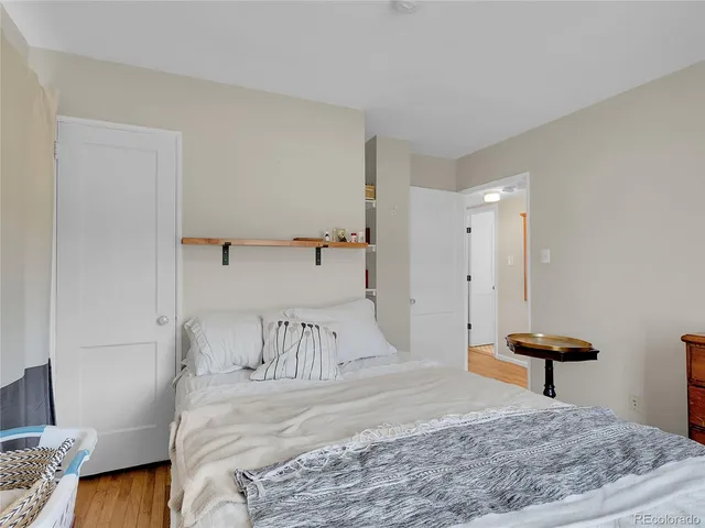 a bedroom with a bed and a dresser in it