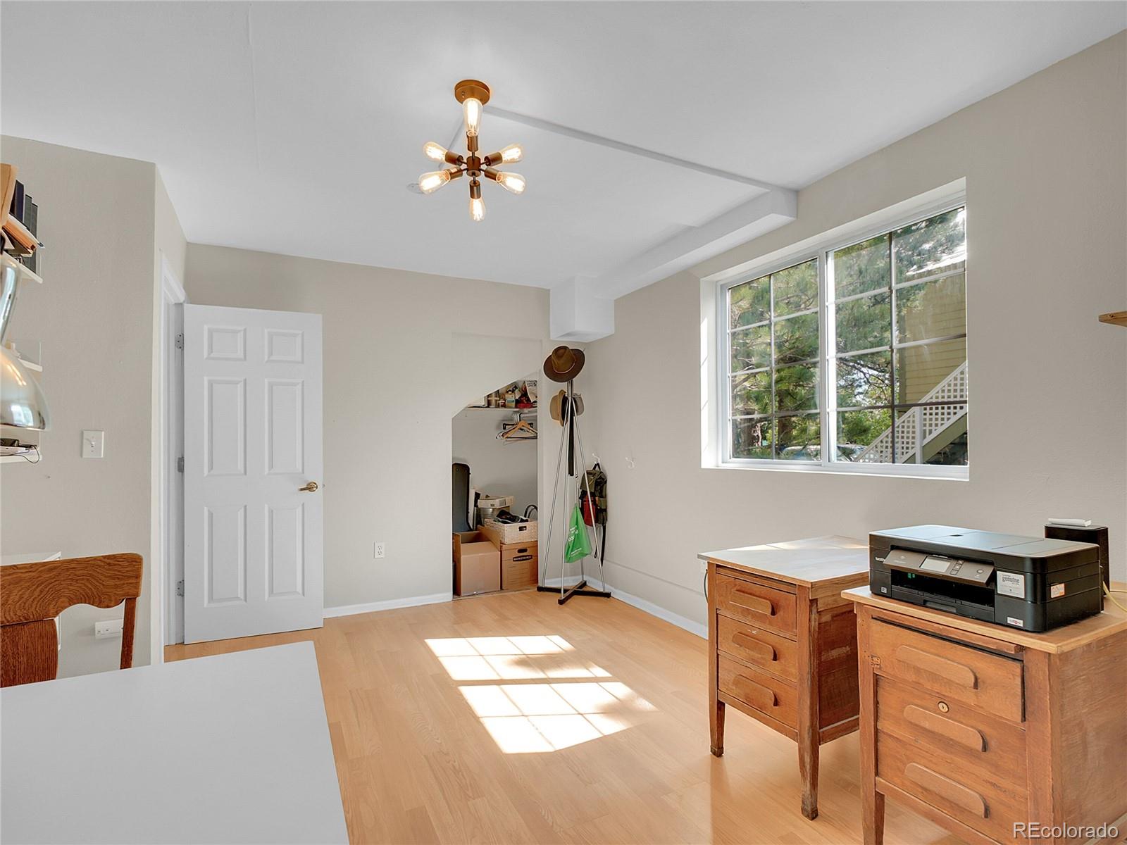 660 West Spruce Street Nederland, CO 80466 - Photo 24 of 29 a bedroom with a bed and a chandelier