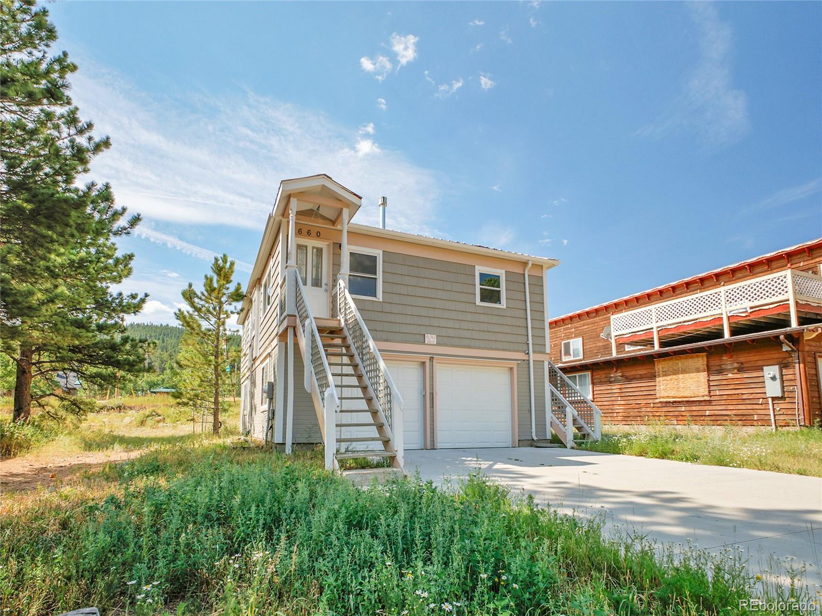 660 West Spruce Street Nederland, CO 80466 - Photo 8 of 29 a view of a house with a yard and garage