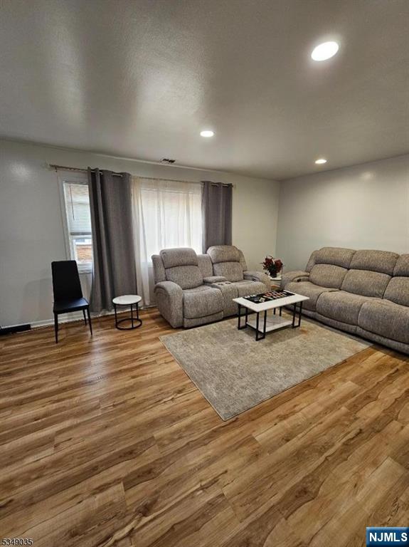 120 Sherwood Avenue, Unit 102 Paterson, NJ 07502 - Photo 3 of 13 a living room with furniture and a flat screen tv