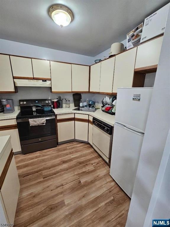 120 Sherwood Avenue, Unit 102 Paterson, NJ 07502 - Photo 5 of 13 a kitchen with a sink a stove top oven and refrigerator