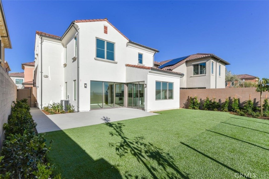 102 Winnett Irvine, CA 92602 - Photo 5 of 9 a front view of a house with a garden and yard