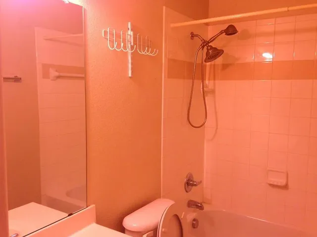 an empty room with a closet and mirror