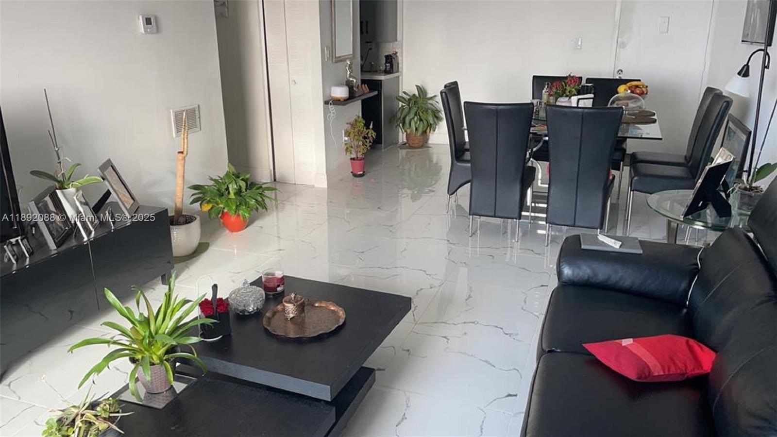 a living room with furniture and flowers