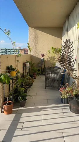 a view of balcony with wooden floor and outdoor seating