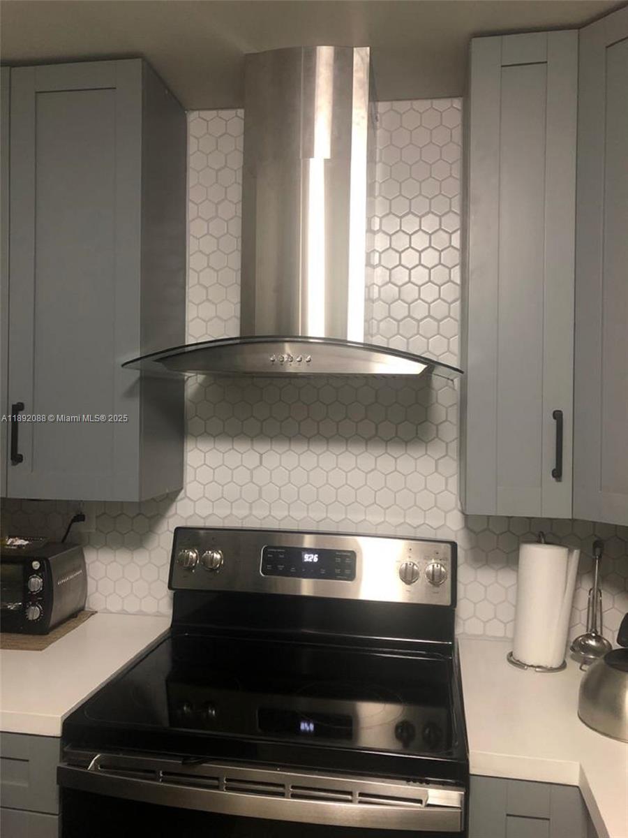 4675 West 18th Court, Unit 1011 Hialeah, FL 33012 - Photo 5 of 16 a stove top oven sitting inside of a kitchen