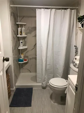 a bathroom with a toilet and a shower