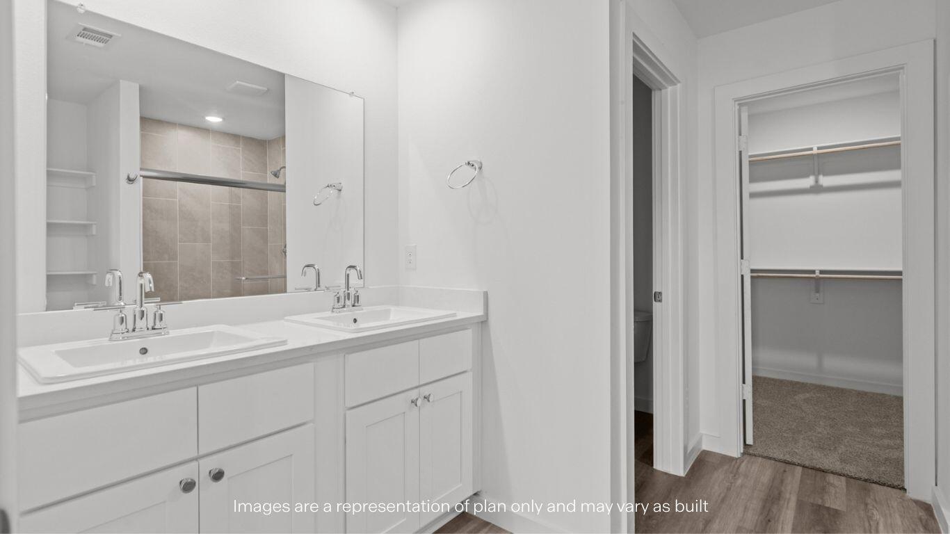 7411 9th Street Lubbock, TX 79416 - Photo 11 of 20 a bathroom with a double vanity sink and mirror