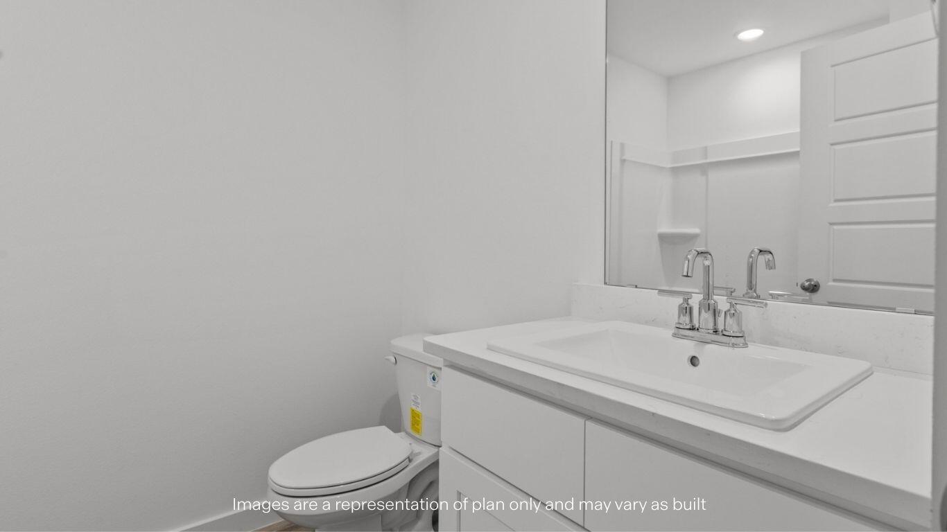 7411 9th Street Lubbock, TX 79416 - Photo 15 of 20 a bathroom with a sink a toilet and mirror