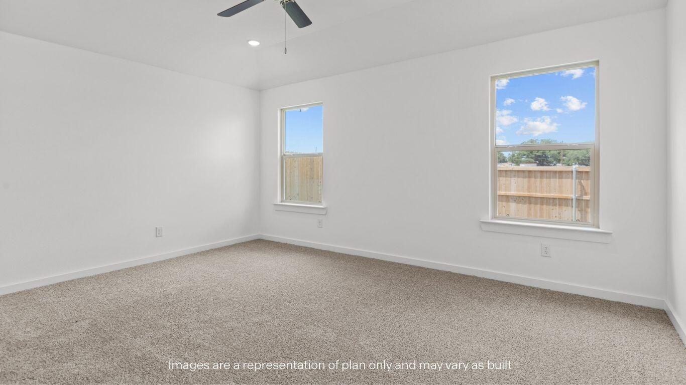 7411 9th Street Lubbock, TX 79416 - Photo 9 of 20 an empty room with a window and a ceiling fan