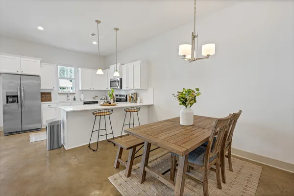 a kitchen with a table and chairs in it