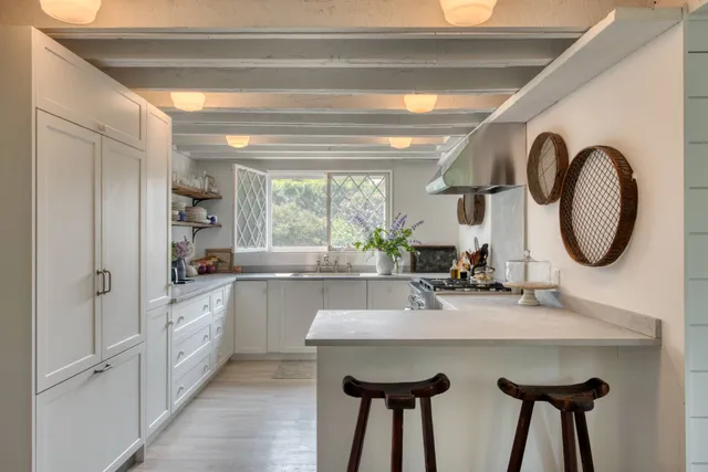 a kitchen with kitchen island a sink and a stove with wooden floor