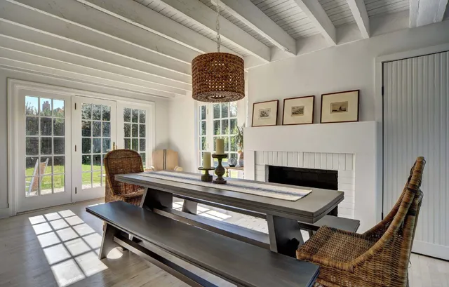 a living room with furniture a table and a large window