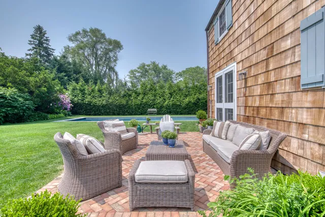 a view of a patio with couches chairs and a fire pit