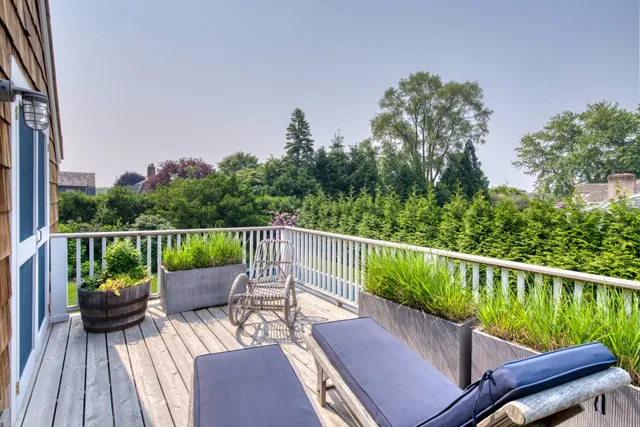 a view of a deck with two chairs next to a yard