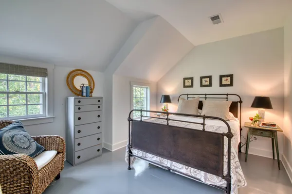 a bedroom with furniture and window