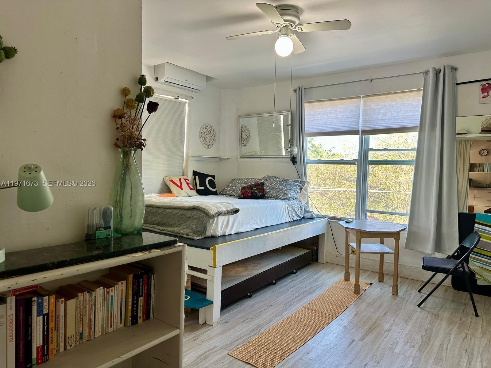 a bedroom with a bed and a table in it