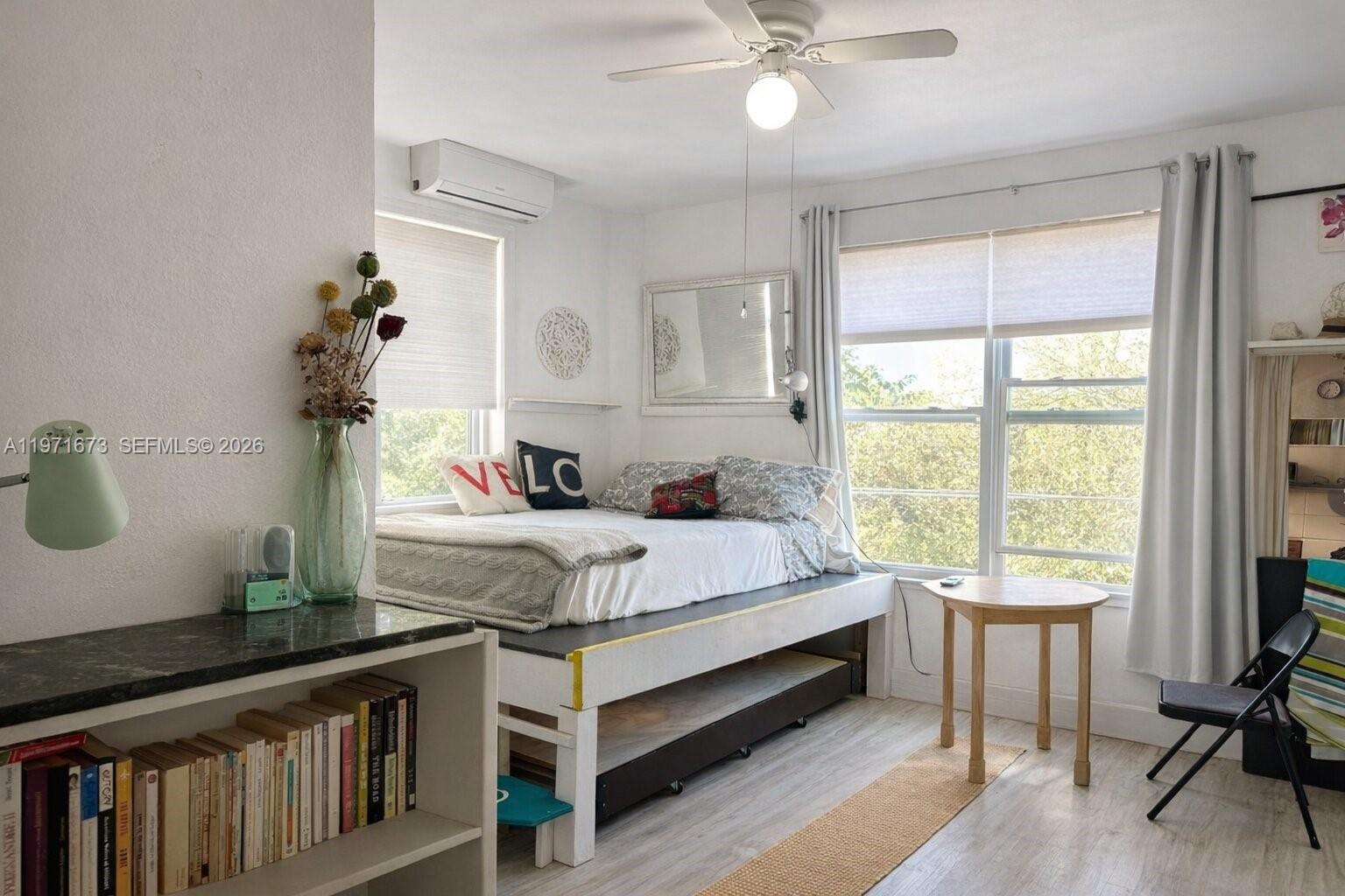 a bed room with a bed and a chandelier