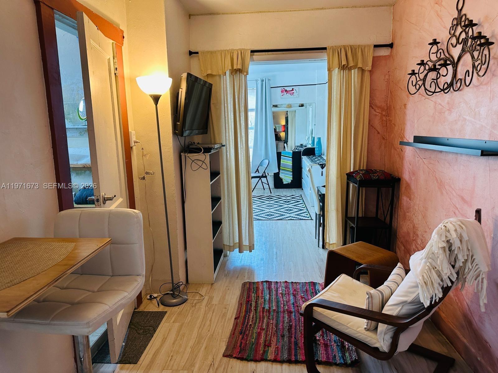 428 Southwest 9th Street, Unit 15 Miami, FL 33130 - Photo 2 of 13 a living room with furniture a wooden floor and a sink