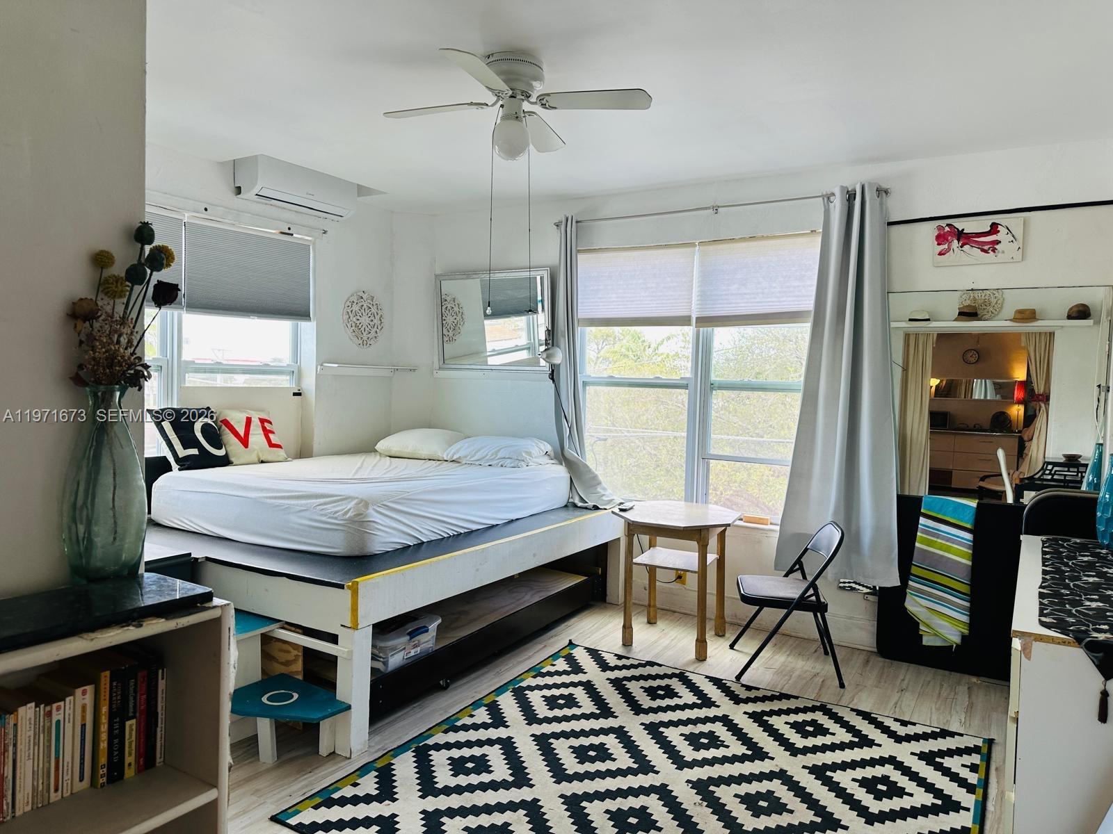 428 Southwest 9th Street, Unit 15 Miami, FL 33130 - Photo 4 of 13 a bed sitting in a bedroom next to a window