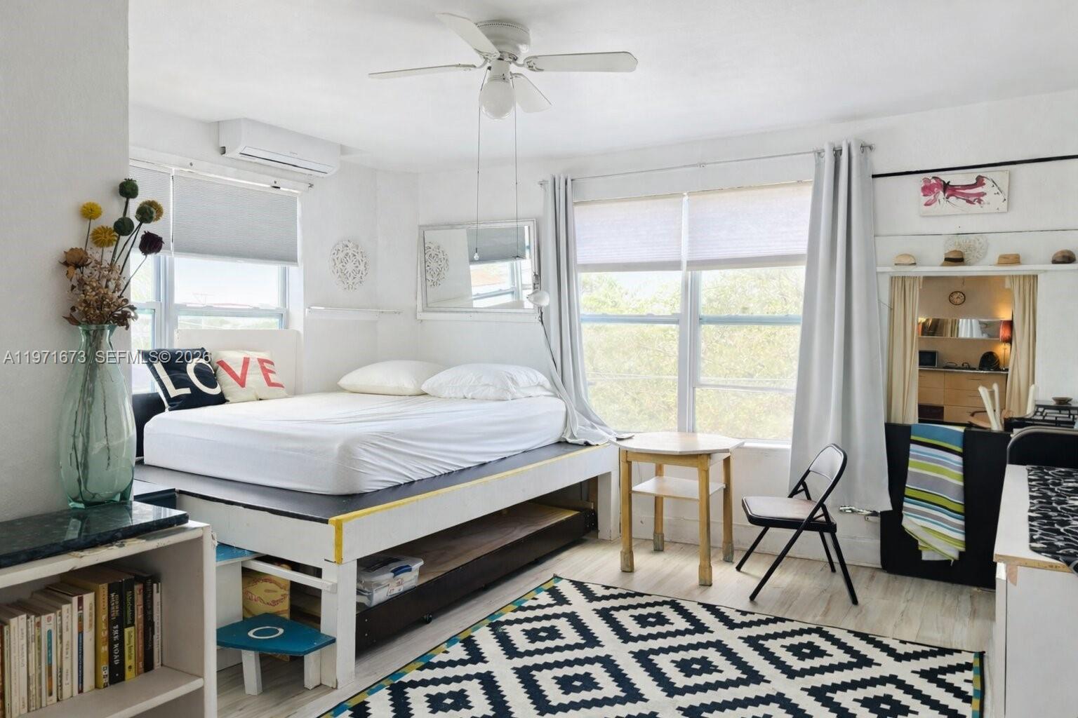 428 Southwest 9th Street, Unit 15 Miami, FL 33130 - Photo 4 of 13 a bedroom with a bed and a chandelier