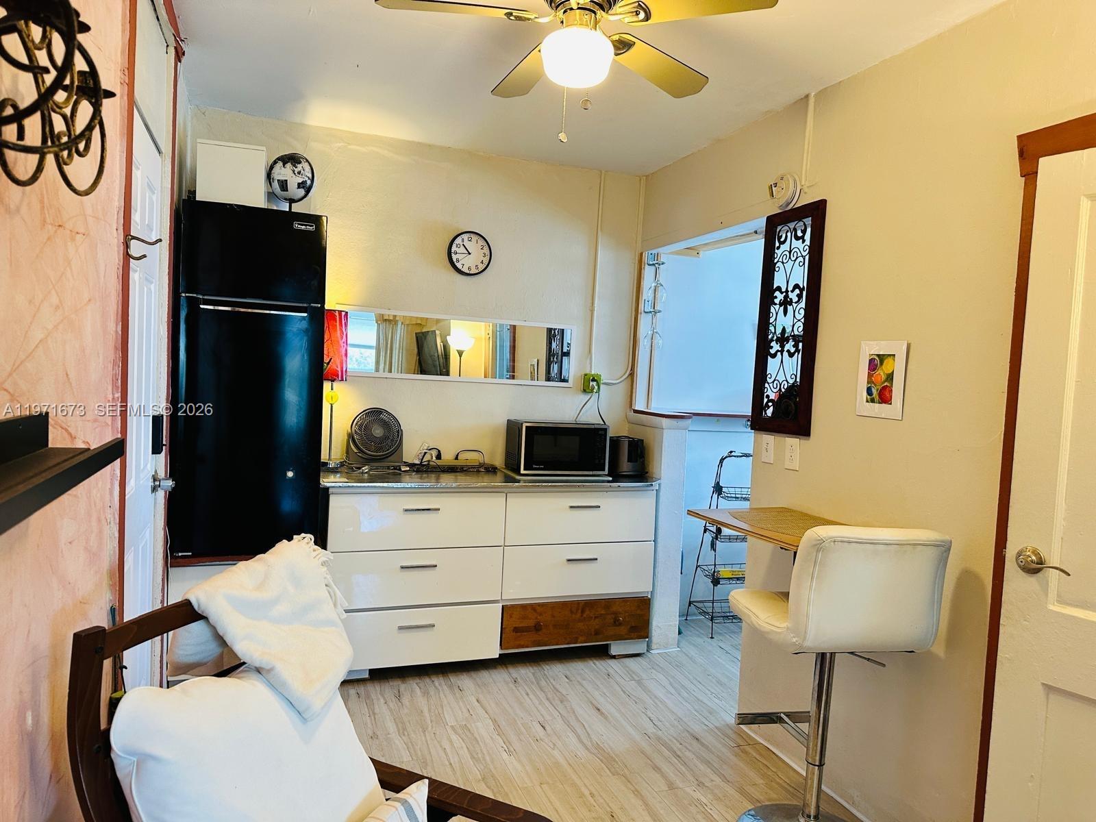 428 Southwest 9th Street, Unit 15 Miami, FL 33130 - Photo 6 of 13 a living room with furniture and a wooden floor