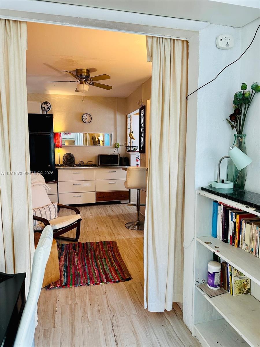 428 Southwest 9th Street, Unit 15 Miami, FL 33130 - Photo 7 of 13 a living room with furniture and a book shelf