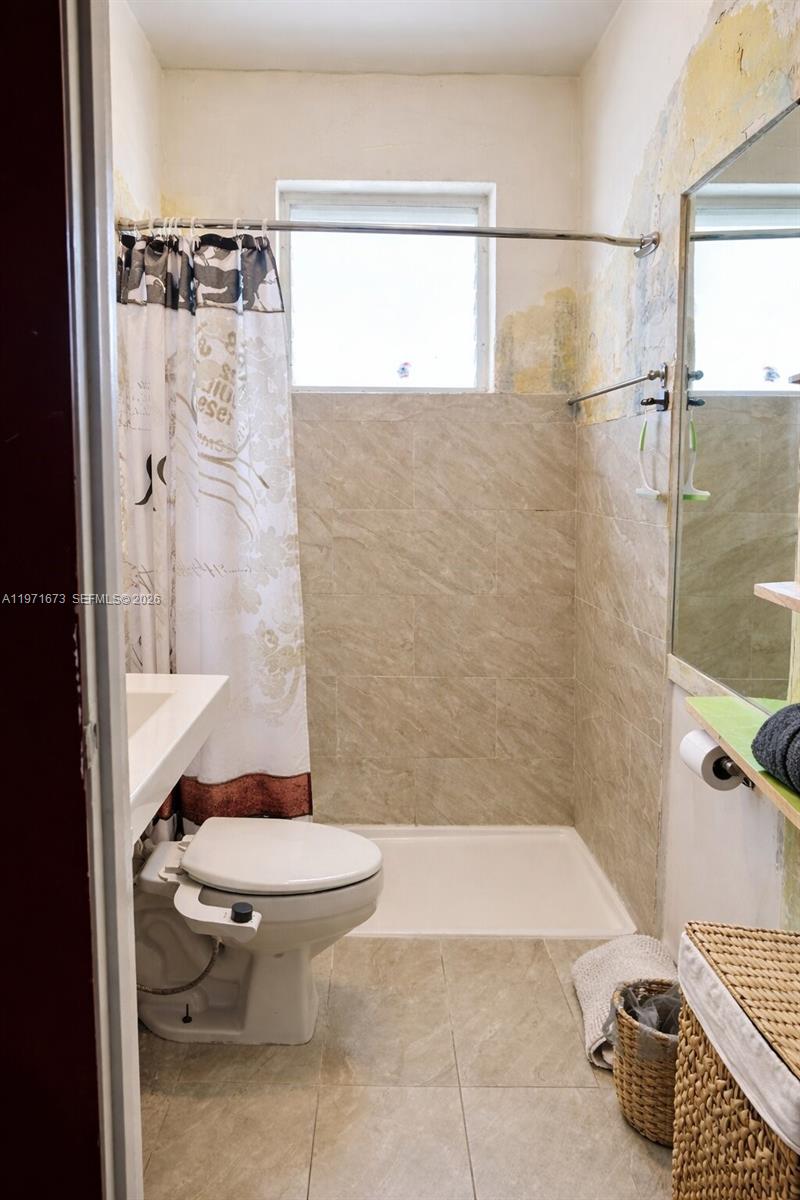 428 Southwest 9th Street, Unit 15 Miami, FL 33130 - Photo 9 of 13 a bathroom with a toilet and a shower