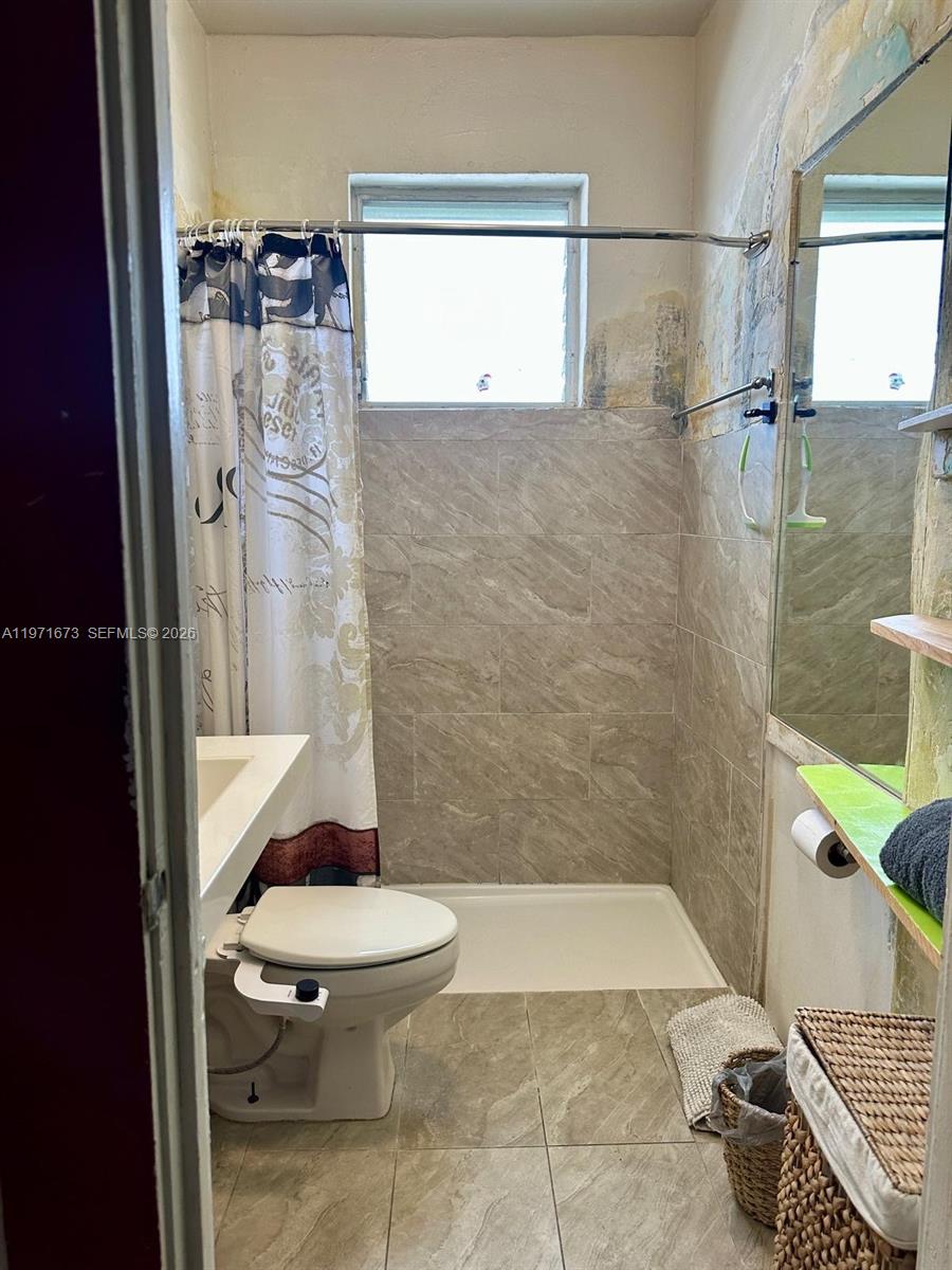 428 Southwest 9th Street, Unit 15 Miami, FL 33130 - Photo 10 of 13 a bathroom with a toilet and a shower