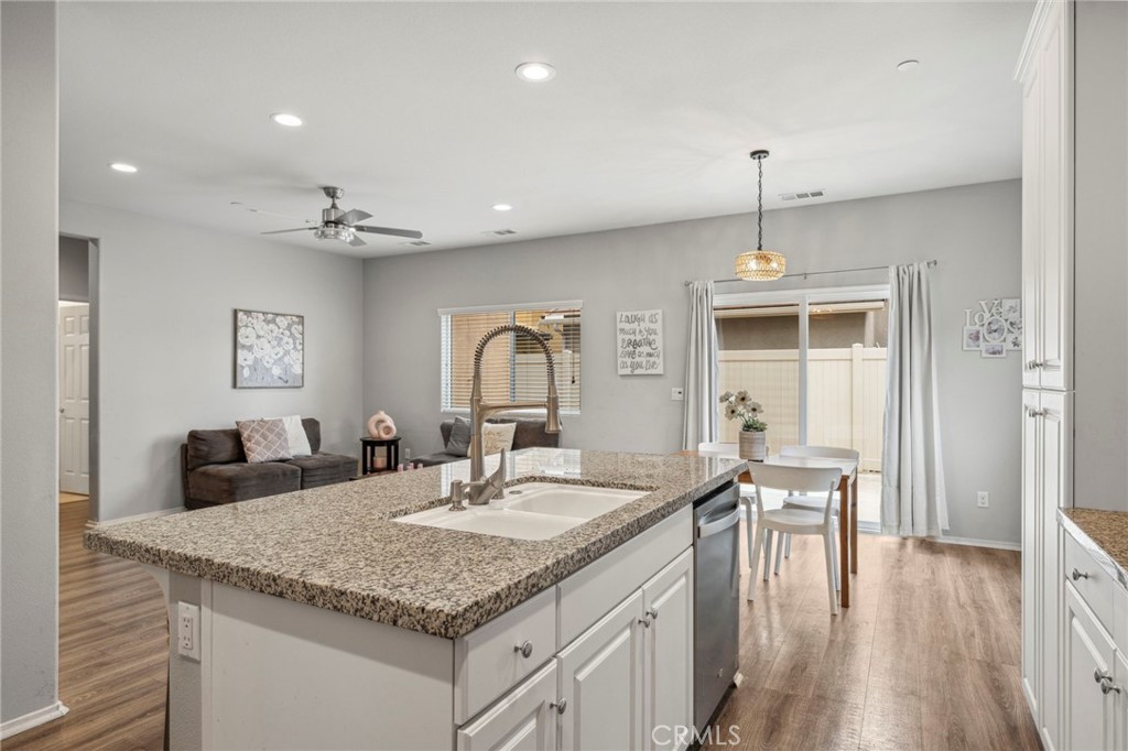 205 Spotted Saddle Way Fallbrook, CA 92028 - Photo 14 of 63 a kitchen with center island a sink stainless steel appliances and wooden floor