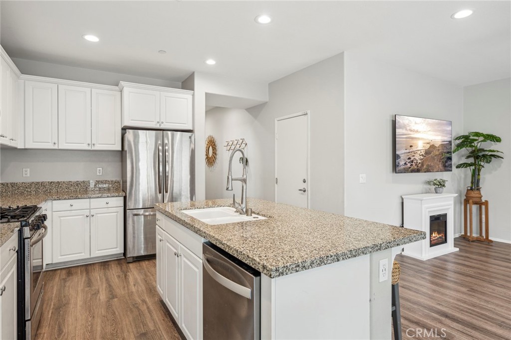 205 Spotted Saddle Way Fallbrook, CA 92028 - Photo 15 of 63 a kitchen with a stove a sink and a refrigerator