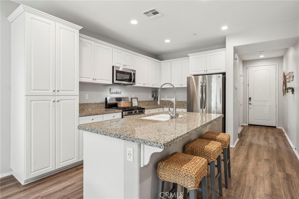 205 Spotted Saddle Way Fallbrook, CA 92028 - Photo 2 of 63 a kitchen with stainless steel appliances granite countertop a refrigerator a stove and a sink