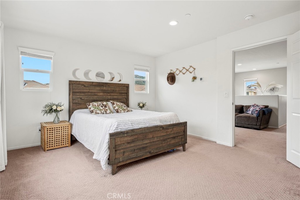 205 Spotted Saddle Way Fallbrook, CA 92028 - Photo 23 of 63 a spacious bedroom with a bed and a couch
