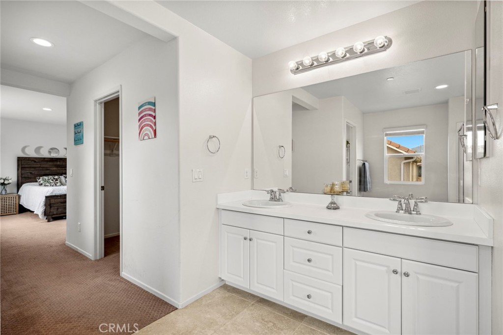 205 Spotted Saddle Way Fallbrook, CA 92028 - Photo 31 of 63 a en suite bathroom with double sink and a mirror