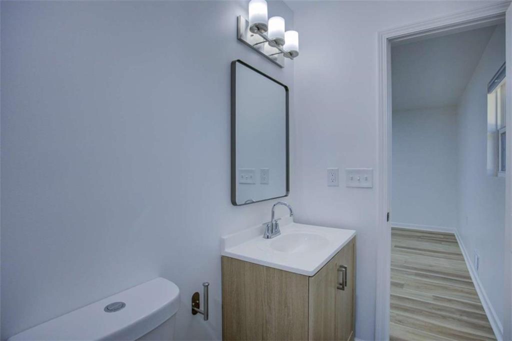 7225 Pineneedle Drive Southwest Covington, GA 30014 - Photo 20 of 37 a bathroom with a sink a light fixture and a mirror
