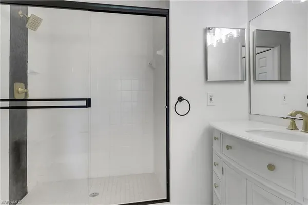 a bathroom with a double vanity sink and a mirror
