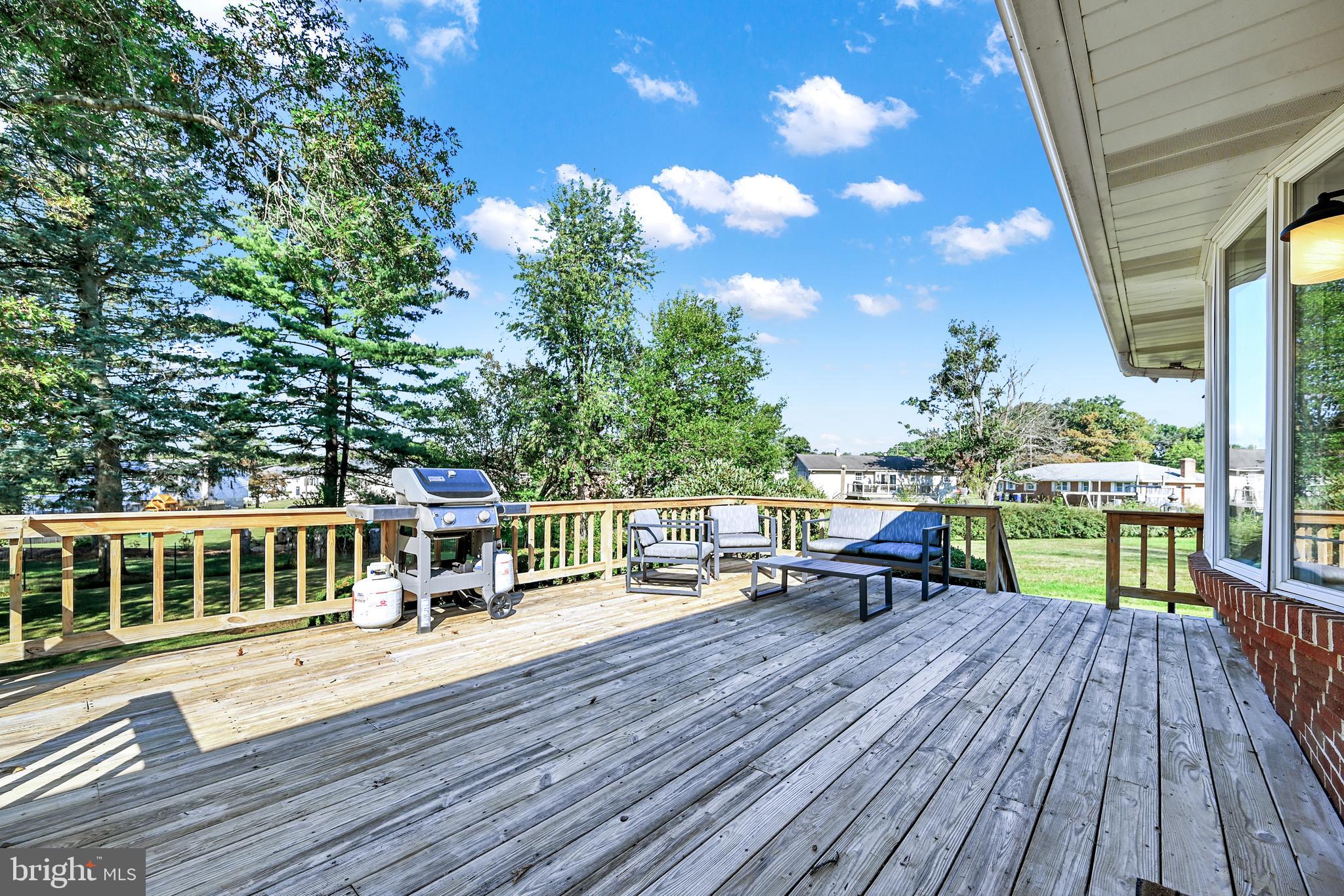 2340 Redwood Road York, PA 17408 - Photo 62 of 68 a view of a roof deck with table and chairs with wooden floor and fence