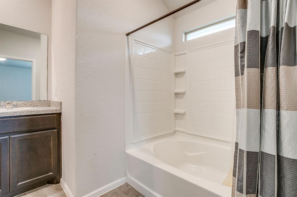 2313 Stallings Road Fort Worth, TX 76108 - Photo 19 of 30 a bathroom with a bathtub and a sink