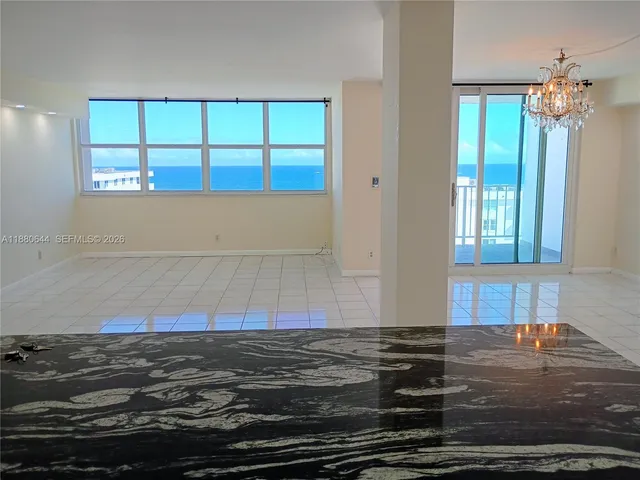 a kitchen with kitchen island granite countertop a stove and a refrigerator