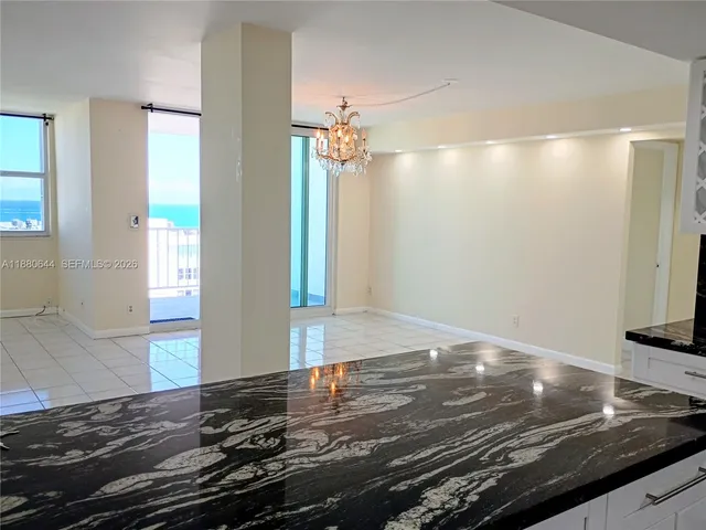 a kitchen with kitchen island granite countertop a sink stainless steel appliances and cabinets